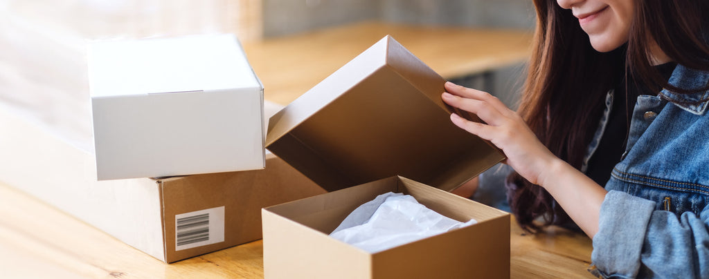 Happy woman opening a parcel box